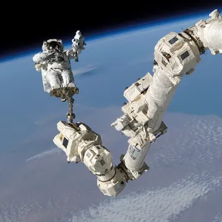 An astronaut works outside the International Space Station