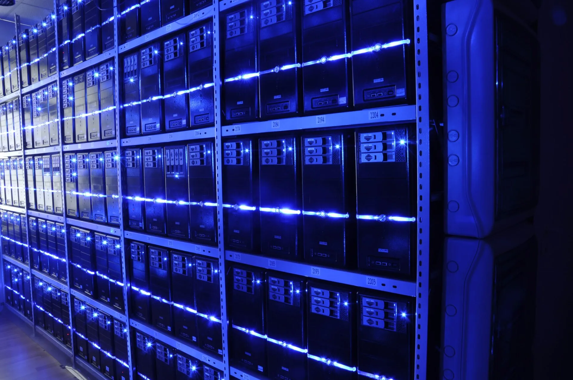 Rows of illuminated server racks in a data centre