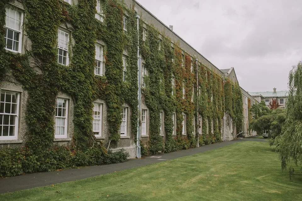 An ivy-covered university building in autumn