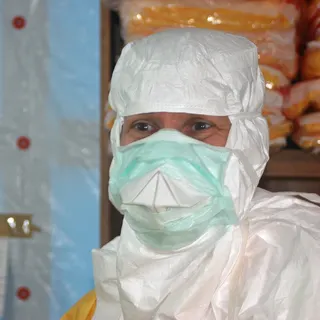 The director of the U.S. Centers for Disease Control and Prevention enters an Ebola treatment unit during an earlier outbreak.