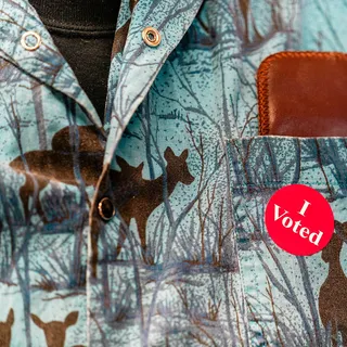 An 'I Voted' sticker on a voter's shirt